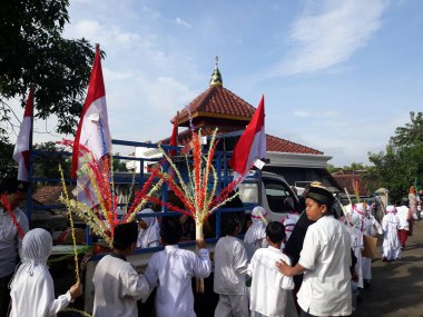 Surabaya, East Java, Indonesia - February, 2023 : Selective focus Elementary school children's parade in commemoration of the Prophet Muhammad's Isra and Miraj