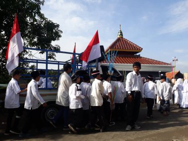 Surabaya, East Java, Indonesia - February, 2023 : Selective focus Elementary school children's parade in commemoration of the Prophet Muhammad's Isra and Miraj