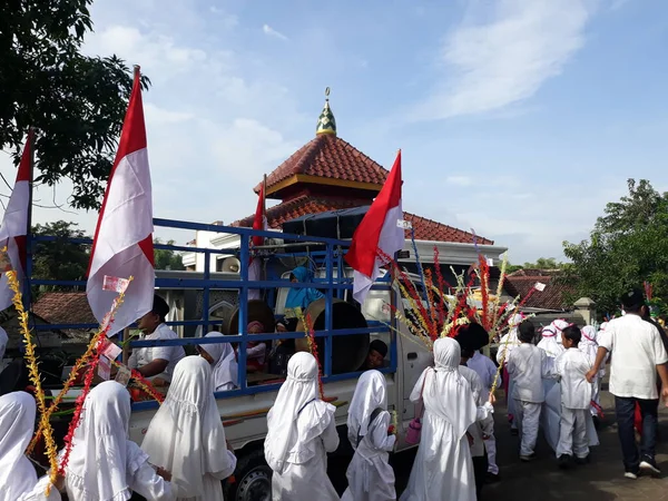 Surabaya, East Java, Indonesia - February, 2023 : Selective focus Elementary school children's parade in commemoration of the Prophet Muhammad's Isra and Miraj