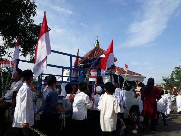 Surabaya, East Java, Indonesia - February, 2023 : Selective focus Elementary school children's parade in commemoration of the Prophet Muhammad's Isra and Miraj