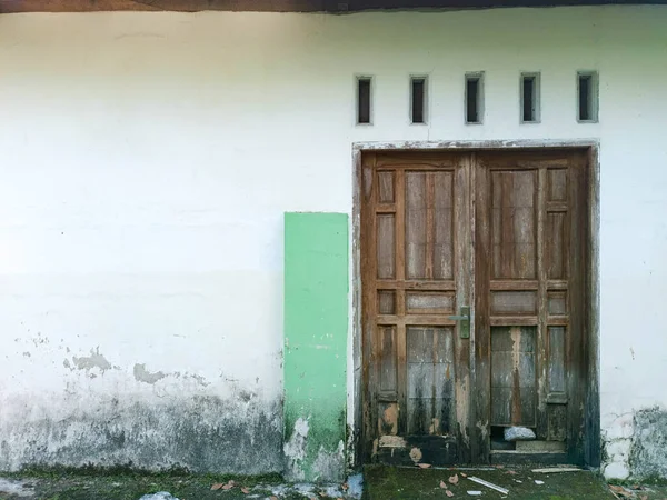 stock image Traditional two wooden door with white wall. Kediri, East Java, Indonesia. October 09, 2022.