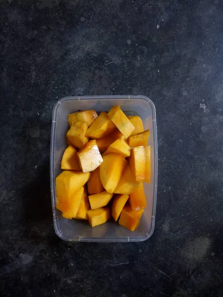 mango slices served in a plastic container