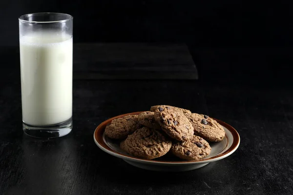 stock image cookies and milk on black background. Space for text