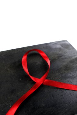 Eski ahşap arka planda kırmızı yardımcı kurdele