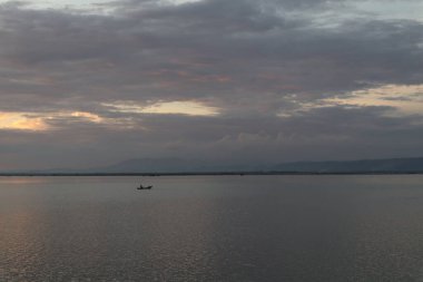 Fisherman Silhouette on His Boat