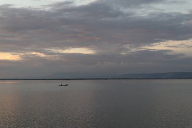 Fisherman Silhouette on His Boat