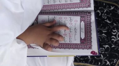 little girl reading the Quran. Islamic conce