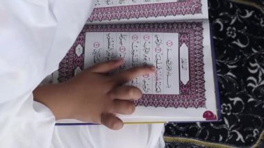 little girl reading the Quran. Islamic conce