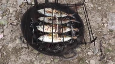 the process of making grilled fish that is burned over coconut shell coals