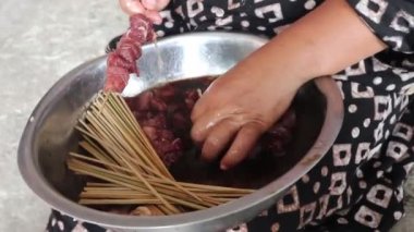 Process of making satay, a traditional Indonesian cuisine dish