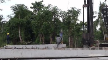 Indonesia - January 2023 - Projects of river widening and the construction of dykes around the Limboto lake area. cement pillar installed as a barrier to waves and currents or embankments on the banks of the river due to rapid river abrasion