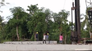 Indonesia - January 2023 - Projects of river widening and the construction of dykes around the Limboto lake area. cement pillar installed as a barrier to waves and currents or embankments on the banks of the river due to rapid river abrasion