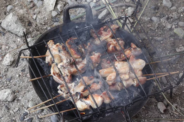 stock image Chicken satay being grilled over coals