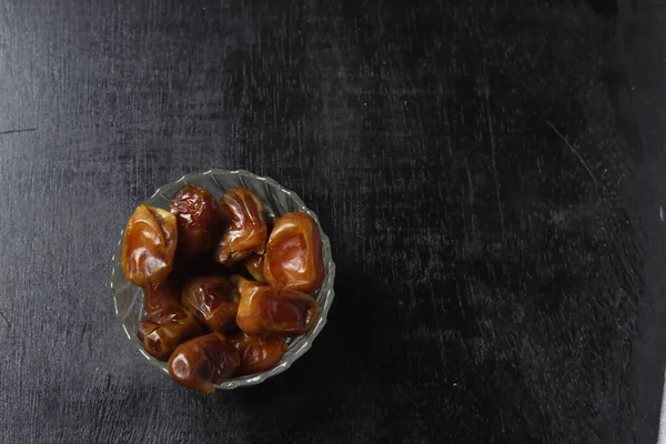 stock image Bowl of dried dates isolated on black background