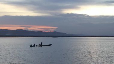 Fisherman Silhouette on His Boat