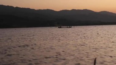 Fisherman Silhouette on His Boat