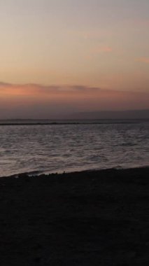 Vertical video of a Beautiful view of the sunset on a summer day. lake sunset