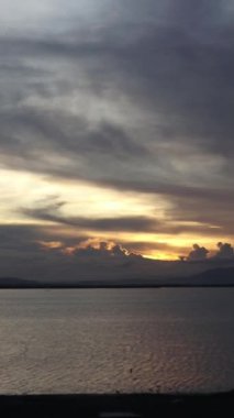 Vertical video of a Beautiful view of the sunset on a summer day. lake sunset