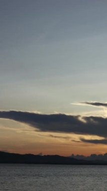 Vertical video of a Beautiful view of the sunset on a summer day. lake sunset