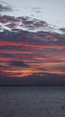 Vertical video of a Beautiful view of the sunset on a summer day. lake sunset