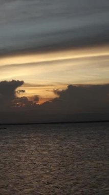 Vertical video of a Beautiful view of the sunset on a summer day. lake sunset