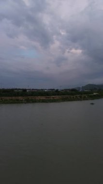 Vertical drone footage of over the water of the lake. Aerial view of lake. 