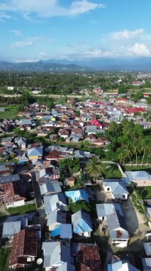 Vertical aerial footage of Small Town in the Morning. Aerial View of Tualango Village in Gorontalo, Indonesia
