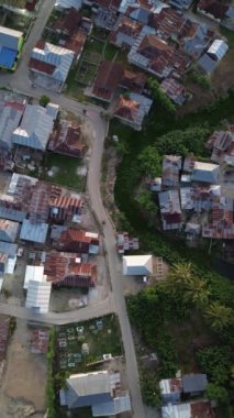 Vertical aerial footage of Small Town in the Morning. Aerial View of Tualango Village in Gorontalo, Indonesia