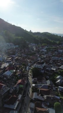 Vertical aerial footage of Small Town in the Morning. Aerial View of Tualango Village in Gorontalo, Indonesia