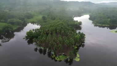 Aerial view of Perintis Lake surrounded by trees