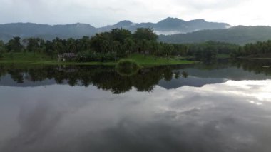 Aerial view of Perintis Lake surrounded by trees