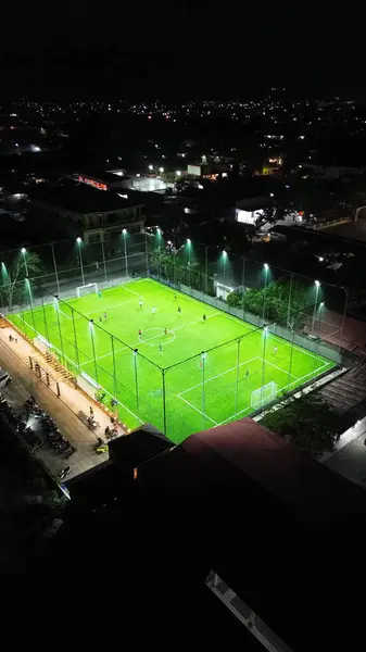Aerial view of mini football match, soccer. MiniFootball field and Footballers from drone