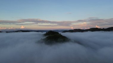 Aerial view of fog in the mountain at Gorontalo, Indonesia. Sunrise over the clouds in the morning clipart