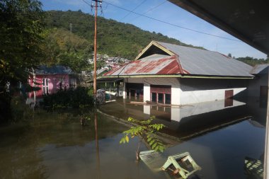 Houses submerged in floods in the village of Tualango, Gorontalo, Indonesia clipart