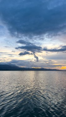 Karanlık 'ta Bulutlu Gökyüzü Altında Sakin Okyanus Suyu