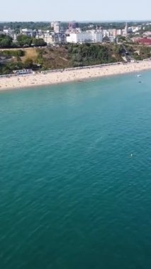 BİRLİK KINGDOM, BOURNEMOUTH BEACH - 18 Temmuz 2022: insanlar yaz tatillerinde eğleniyorlar. Yüksek Açı Drone Kamera Görünümü