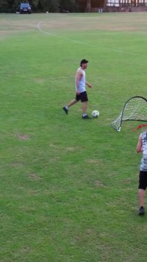 İngiltere, İngiltere, LUTON - 11 Mart 2023: Şehir parkında futbol oynayan gençlerin yavaş çekim görüntüleri 