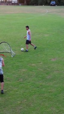 İngiltere, İngiltere, LUTON - 11 Mart 2023: Şehir parkında futbol oynayan gençlerin yavaş çekim görüntüleri 