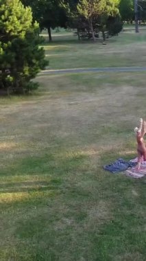 ENGLAND, LUTON TOWN - 04th April 2022: Genç İngiliz Kadınlardan oluşan bir grup, Wardown Halk Parkı Yüksek Açılı Görüntü Parkı 'nda egzersiz yapıyor. Luton Kasabası 'nda Parlak Güneşli Gün