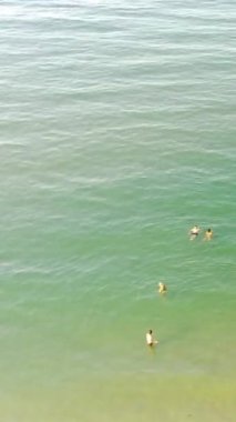 Aerial Footage of people are Relaxing and swimming in the Ocean Water at Beach of Bournemouth England UK