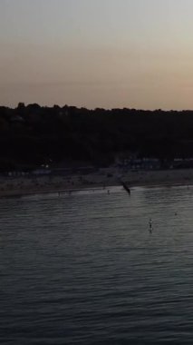 Aerial Footage of people are Relaxing and swimming in the Ocean Water at Beach of Bournemouth England UK