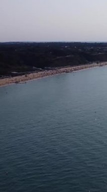 Aerial Footage of people are Relaxing and swimming in the Ocean Water at Beach of Bournemouth England UK