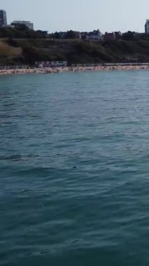 Aerial Footage of people are Relaxing and swimming in the Ocean Water at Beach of Bournemouth England UK