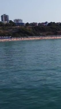 Aerial Footage of people are Relaxing and swimming in the Ocean Water at Beach of Bournemouth England UK