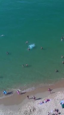 Aerial Footage of people are Relaxing and swimming in the Ocean Water at Beach of Bournemouth England UK