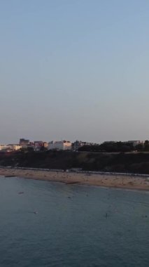 Aerial Footage of people are Relaxing and swimming in the Ocean Water at Beach of Bournemouth England UK