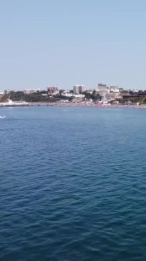 Aerial Footage of people are Relaxing and swimming in the Ocean Water at Beach of Bournemouth England UK