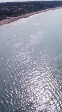 Aerial Footage of people are Relaxing and swimming in the Ocean Water at Beach of Bournemouth England UK