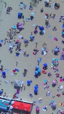 Aerial Footage of people are Relaxing and swimming in the Ocean Water at Beach of Bournemouth England UK