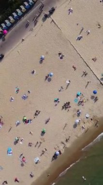 Aerial Footage of people are Relaxing and swimming in the Ocean Water at Beach of Bournemouth England UK